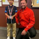 Ian Davison with a junior division student at the CJGA